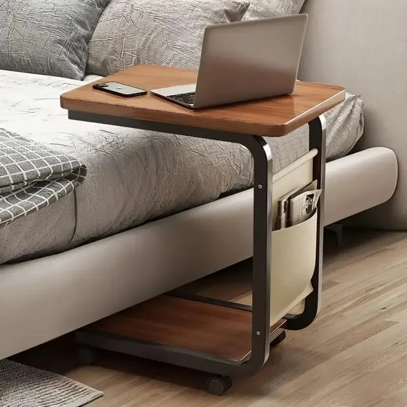 C-Frame Side Table positioned beside sofa holding laptop and coffee mug