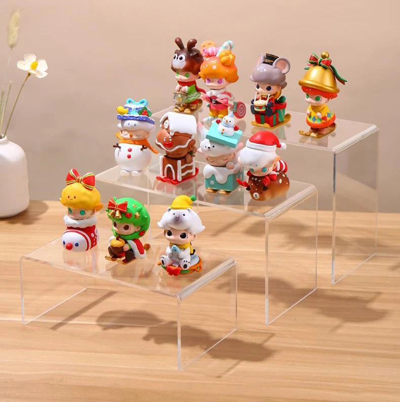 Clear acrylic riser holding figurine on bookshelf display