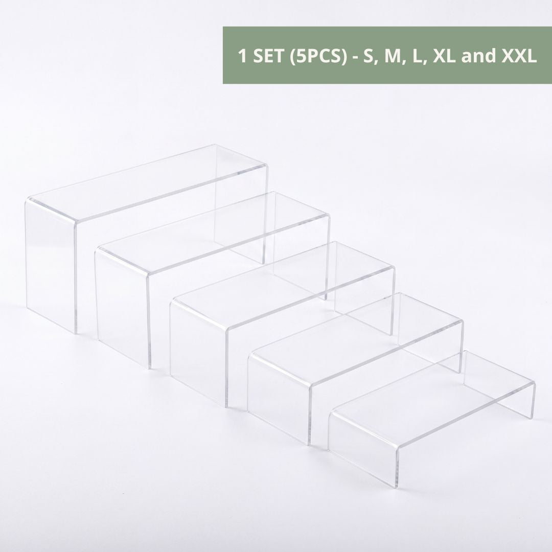 Clear acrylic riser in window display for boutique shop
