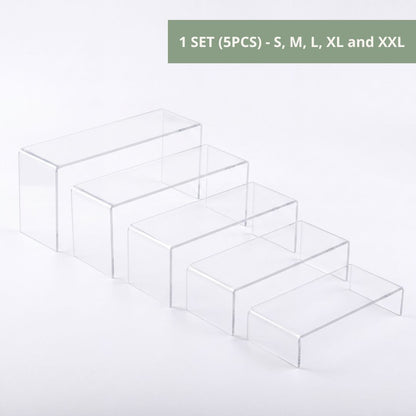 Clear acrylic riser in window display for boutique shop
