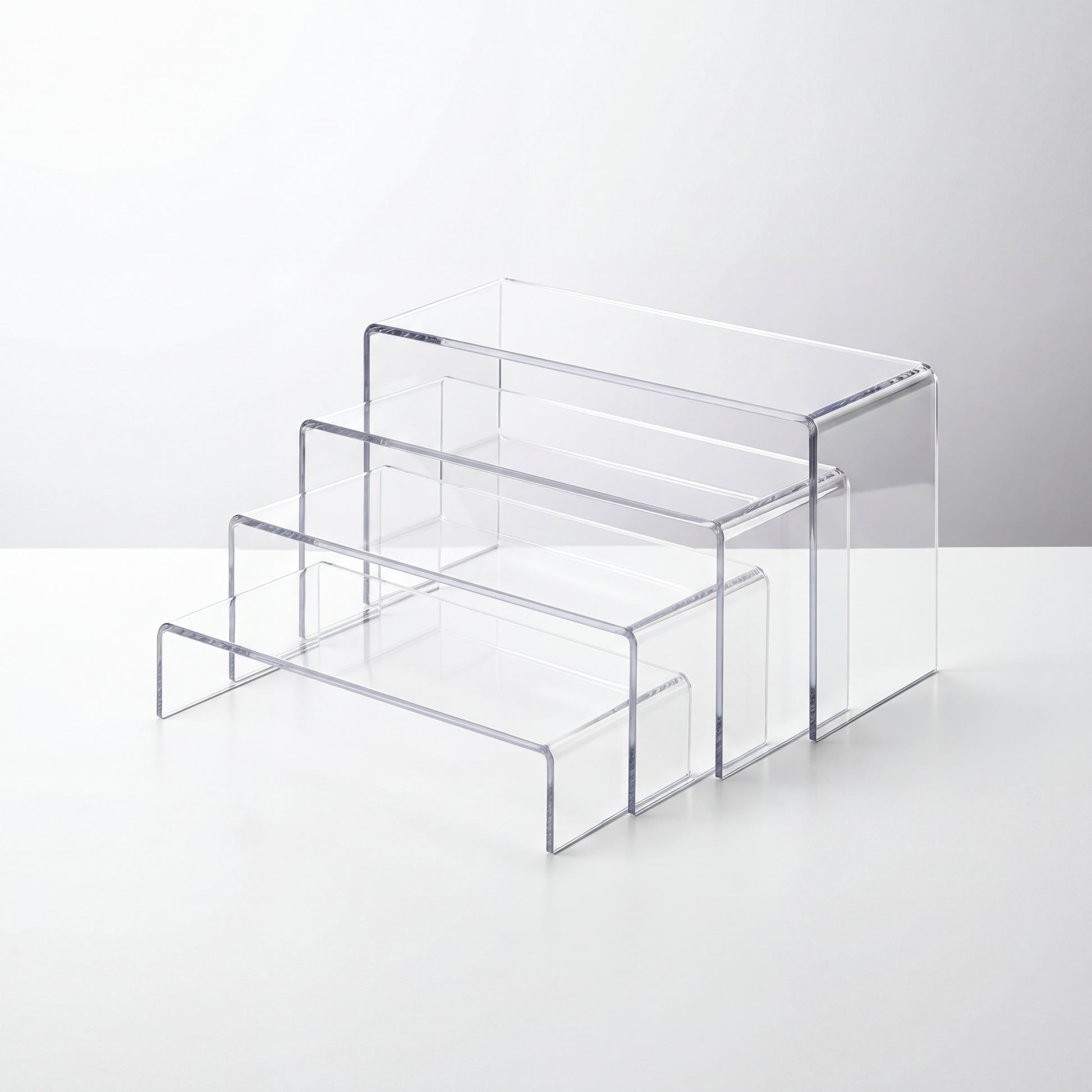 Set of 3 clear acrylic display risers in different heights for countertop organization and product display