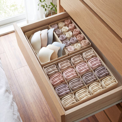 Cream fabric organizer boxes dividing drawer into neat compartments