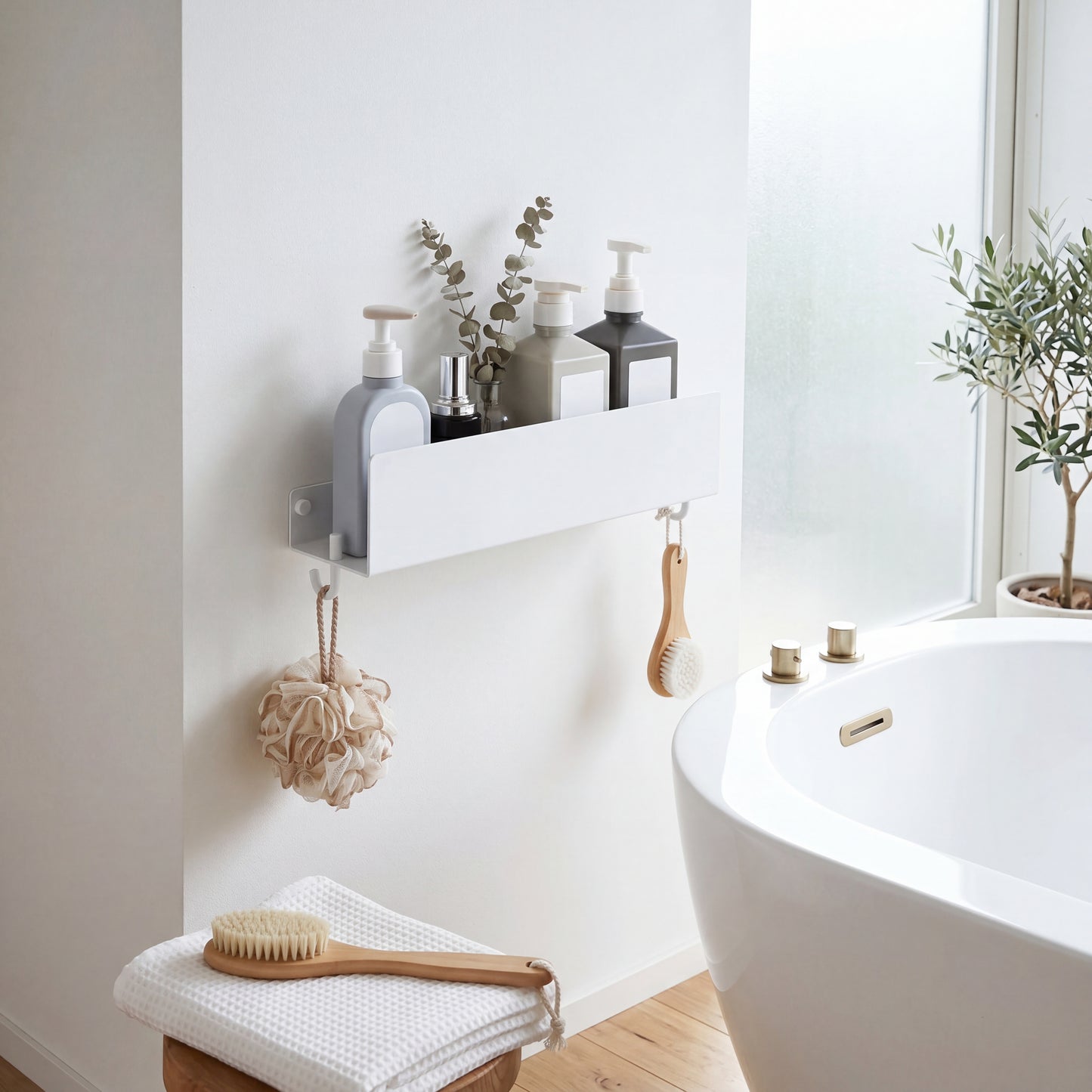 White floating shelf in bathroom holding soap dispenser towels and plants