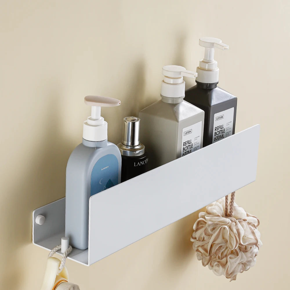 White bathroom floating shelf with decorative items and candles