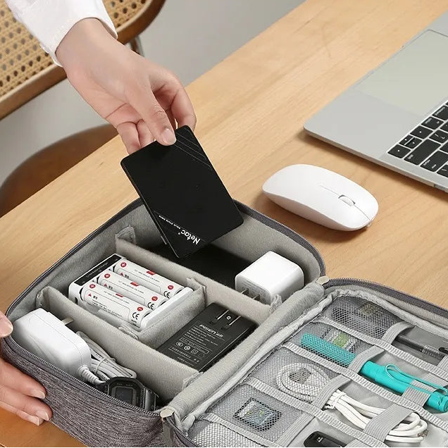Travel Cable Organizer Bag top view with all compartments open and organized
